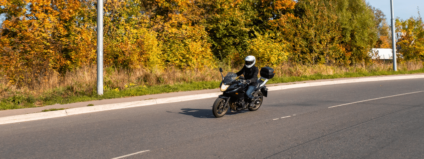 wide view of a motorcyclist practicing helmet law 