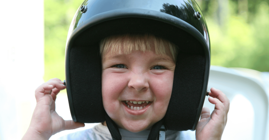 Kid with a motorcycle helmet