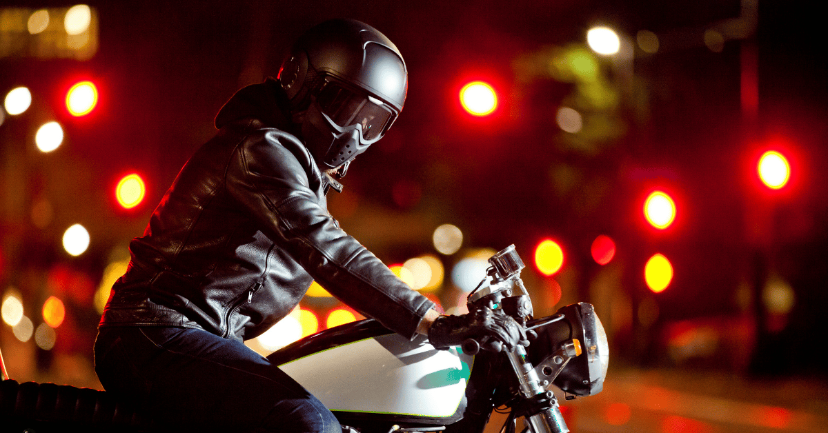 Motorcyclist with gear riding on the night in Denver streets