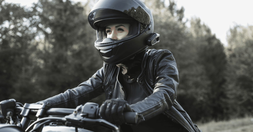 Female, dressed with motorcycle gear, riding her motorcycle in Colorado