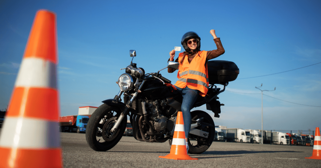 Happy female motorcyclist posing after getting her Motorcycle License