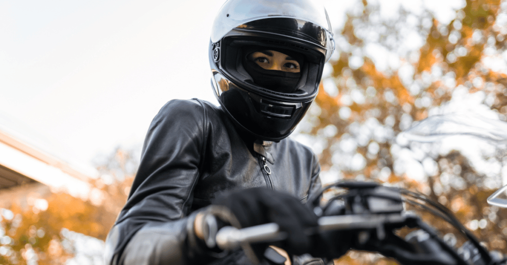 Female motorcyclist dressed in leather riding her motorcycle